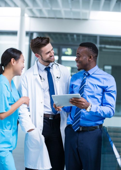 nurse-doctor-having-discussion-with-businessman.jpg